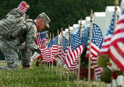 NG soldier placing flags 